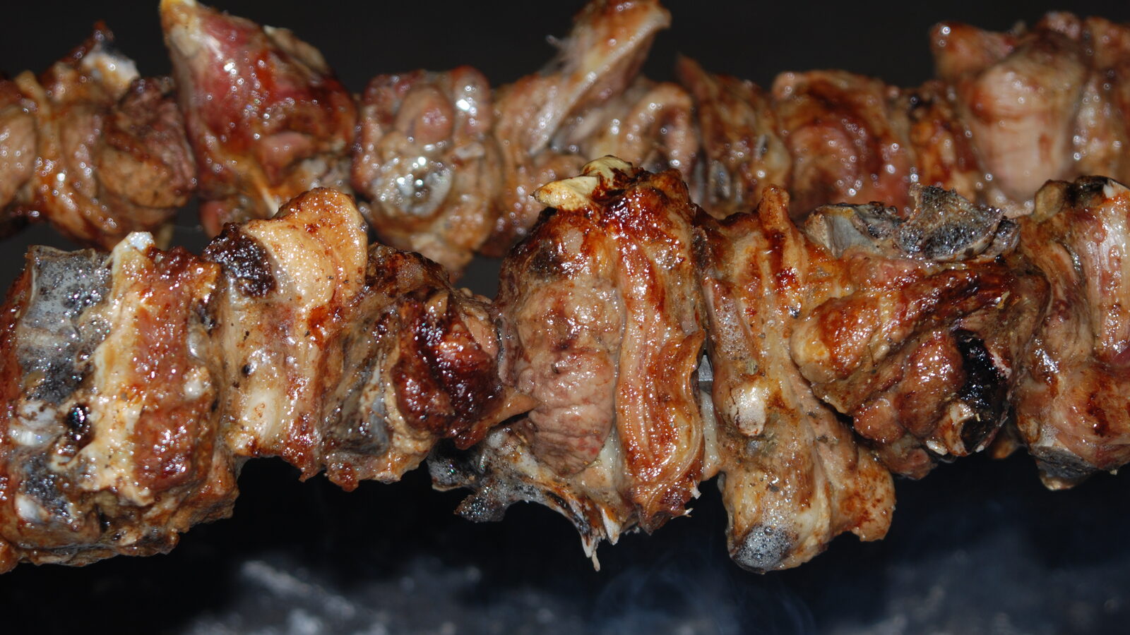 Souvla cooking on skewers over charcoal in Cyprus